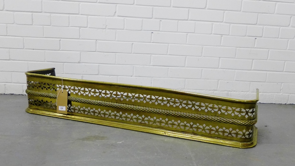 A pierced brass fender, 125 x 35cm