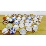 A collection of thirty-four miniature porcelain cup, saucers and tankards to include Helena Wolfsohn