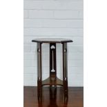 An Arts & Crafts mahogany side table, the octagonal top on shaped supports and undertier with