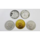 An Austrian Maria Theresia 1780 thaler coin together with another, two Churchill commemorative coins