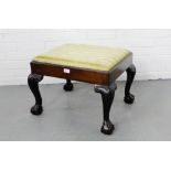 A 19th century mahogany framed foot stool, the upholstered rectangular slip in top raised on