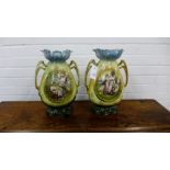 A pair of continental twin handled porcelain vases with gilt rims over painted panels depicting '