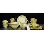 A Grosvenor china honey glazed tea set with rose sprays and gilded rims comprising six cups, six