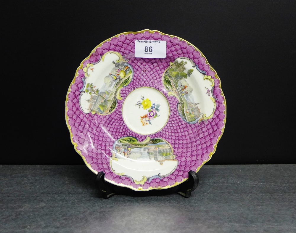 A 19th century Meissen porcelain saucer with a pink fish scale ground with three vignettes painted