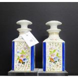 A pair of continental porcelain jar and covers, each of square form, painted with floral sprays