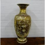 A Japanese Satsuma earthenware floor standing baluster vase with a flaring rim, painted with many