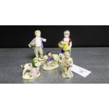 A collection of porcelain figures to include a Naples Cherub, a pair of continental porcelain boy