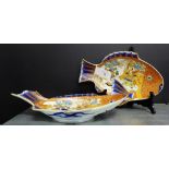 Two Imari fish shaped serving dishes, painted with Warriors, with seven character mark to base,