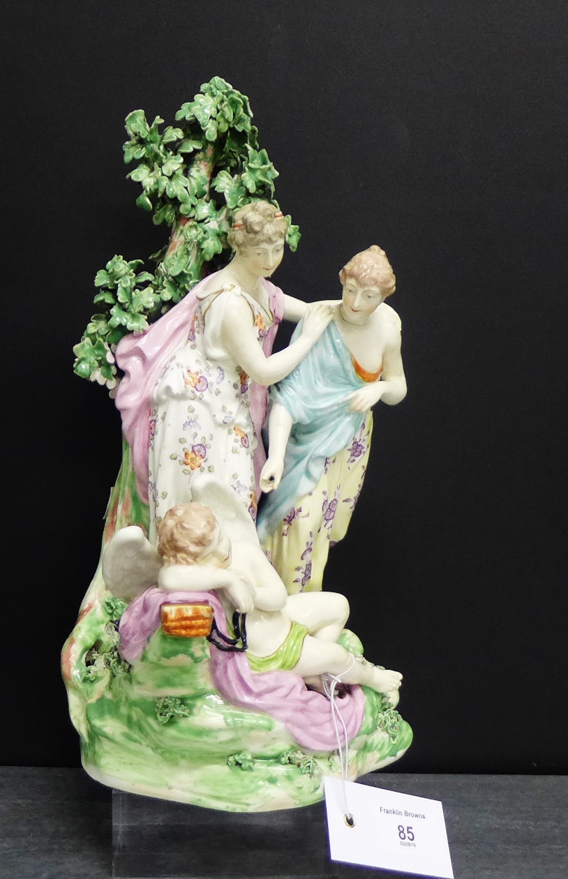 A Derby porcelain figure group depicting two Virgins Awakening Cupid on a floral encrusted