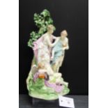A Derby porcelain figure group depicting two Virgins Awakening Cupid on a floral encrusted