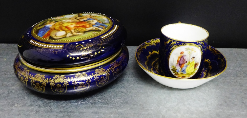 A Vienna porcelain coffee can and saucer painted with figures to a cobalt blue and gilded ground,