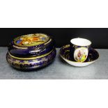 A Vienna porcelain coffee can and saucer painted with figures to a cobalt blue and gilded ground,
