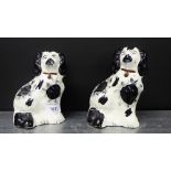 Two small black and white Staffordshire pottery chimney spaniels, 14cm high, (2)