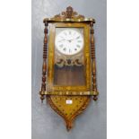 An inlaid Vienna style wall clock case with carved fruit and vine pediment, the painted card dial