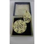 Two bone carved pendants, largest 6cm diaster (2)