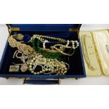 A blue leather jewellery box containing faux pearls, drop earrings, two gemset dress rings and