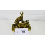 After J. Moigniez a bronze figure group depicting a pair of hares on a naturalistic oval mound,