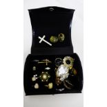 A small black jewellery box containing a collection of costume jewellery to include paste set rings,