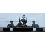 An Art Deco patinated metal and ivorine figure group with a female flanked by Borzoi hounds, on a