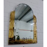 An Art Deco wall mirror, the central domed plate flanked by amber tinted and floral engraved glass