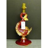 A Murano glass dolphin table lamp in red ribbed glass with clear glass tail and fins with gold