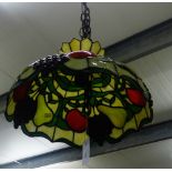 A Tiffany style glass lamp shade with fruit and foliage pattern