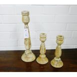 A group of three carved wood candlesticks, tallest 38cm, (3)