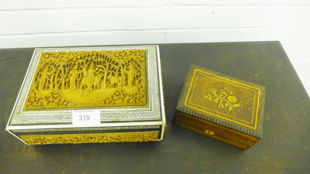 An Eastern box with a carved fruit wood top and stained bone border on four bun feet, together