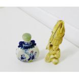 Early 20th century carved ivory Okimono, 12cm high, together with a blue and white scent bottle, (2)