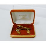 A pair of Lion Rampant yellow metal cufflinks and a Colibri gold plated tie pin (2)