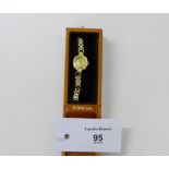 A vintage 9ct gold ladies Omega cocktail watch, the dial with hour batons and inscribed 'Omega',