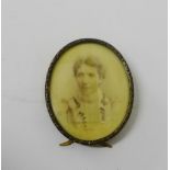 Oval portrait miniature on ivorine plaque contained within a brass frame with easel strut back, 8.