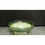 A Strathearn art glass bowl with swirled inclusions to a green ground, 23cm diameter