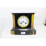 A black slate mantle clock, the white enamel dial with Roman numerals bearing a presentation