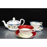 A porcelain teapot, together with a cup and saucer in the 'Fancy bird' pattern, and a