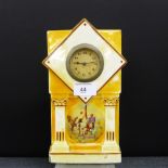 An orange lustre glazed porcelain mantle clock with transfer printed desert scene to front, 25 x