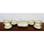 A Cauldon white glazed porcelain teaset with gilt rims comprising twelve teacups, twelve saucers,