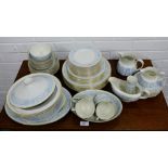 A Royal Doulton Hampton Court patterned dinner service comprising seven dinner plates, seven side