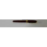 A Parker Sonnet red lacquered and gold plated fountain pen with an 18ct gold nib