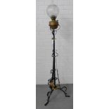 An Art Nouveau black painted metal standard lamp with stylised brass and copper work, complete