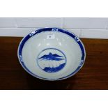 A Chinese blue and white bowl, painted with two figures within brown scratch borders, depicting a