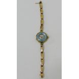 9 carat gold cased cocktail watch with blue enamel chapter ring with Arabic numerals and surround of