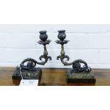 A pair of bronze candlesticks, the rectangular bases surmounted by recumbent lions (2)