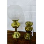 Two brass oil lamps, one with an etched glass shade (2)