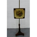 A 19th century pole screen with floral embroidered panel, on a fluted tripod base, 134cm high