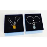 An amber cabouchon pendant on silver chain together with a blue hardstone pendant on silver chain,