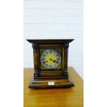 An oak cased mantle clock, the silver chapter ring with Roman numerals with stylised gilt metal