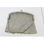 A continental white metal evening bag, the cantle with foliate engraved decoration and a pair of