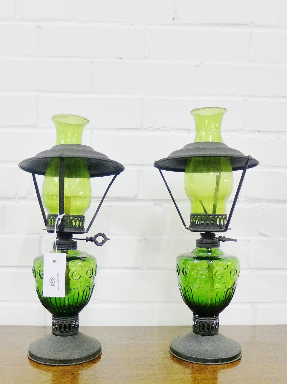 A pair of green moulded glass oil lamps,43cm high, (2)