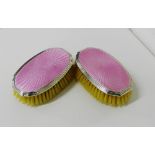 A pair of silver backed and pink enamelled baby brushes, (2)